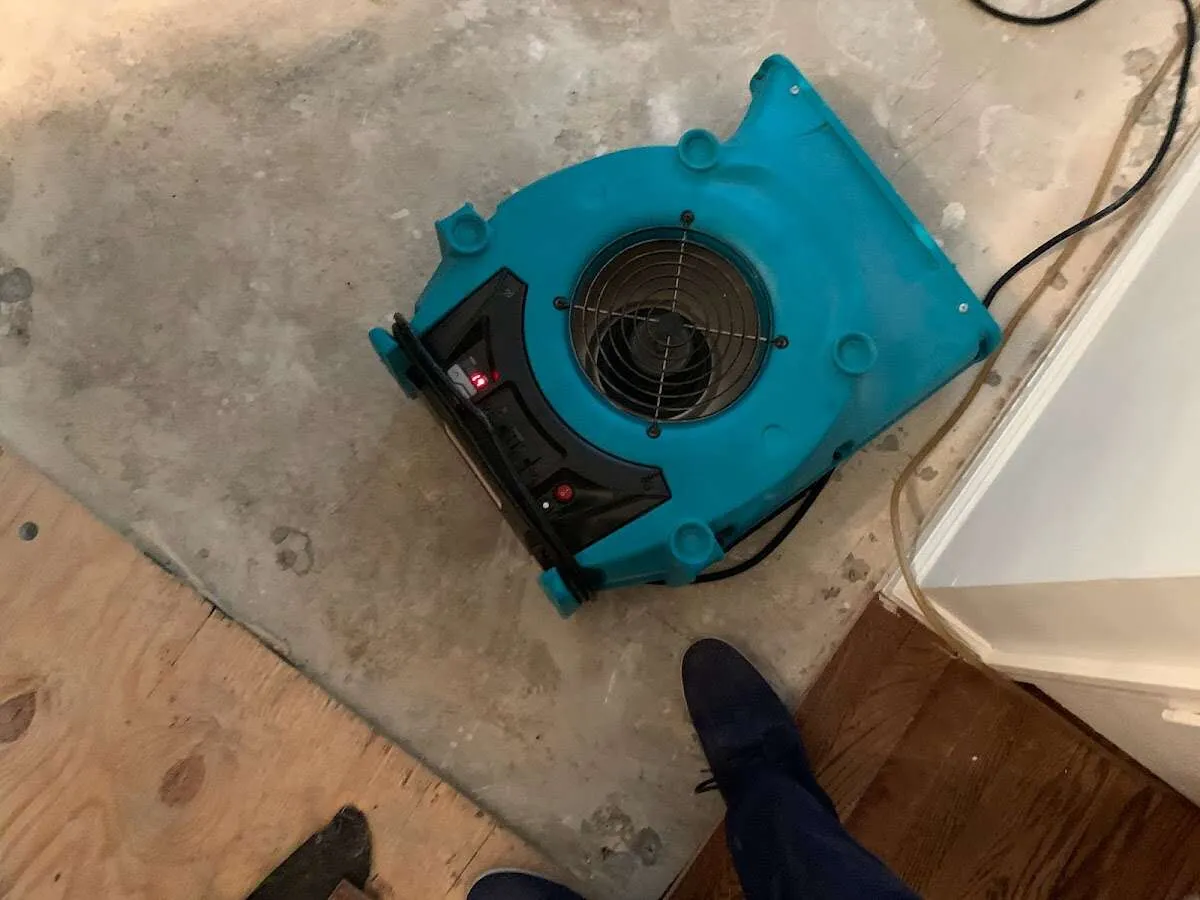 Air mover drying subfloor during Commercial Water Damage Restoration in South Windsor
